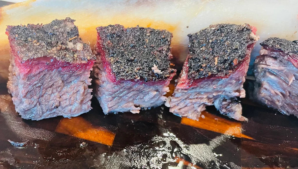 Extreme closeup of the ends of Smoked Beef Plate Ribs showing off the bark and thick smoke rings