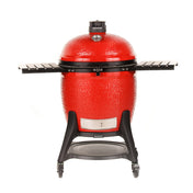 A red Big Joe III grill with black side shelves, Kontrol Tower top vent, and heavy-duty cart with wheels. A temperature gauge is built into the grill dome. A sliding steel access door is built into the bottom of the grill base.